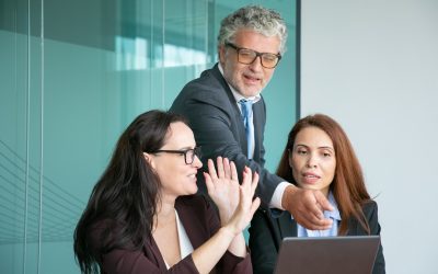 business-team-watching-discussing-presentation-laptop-male-executive-pointing-display_74855-7987