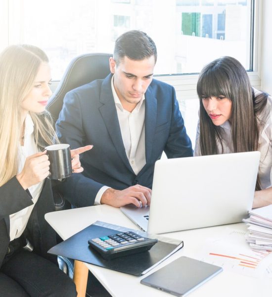 businessman-sitting-with-two-women-working-office_23-2147857250
