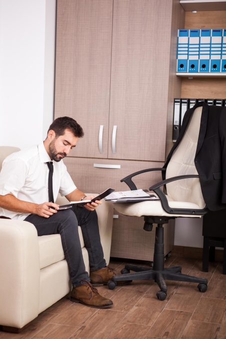 businessman-working-office-couch-putting-long-hours-work-businessperson-professional-environment_482257-32770
