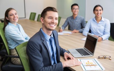 cheerful-young-businessman-sitting-seminar_1262-2088