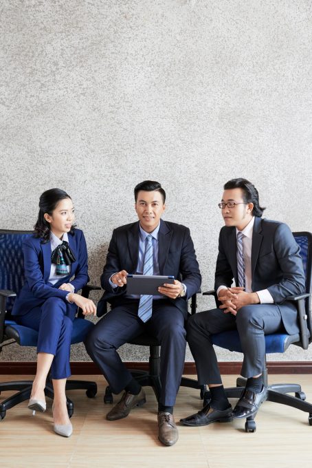 full-shot-three-business-people-sitting-each-other_1098-20770