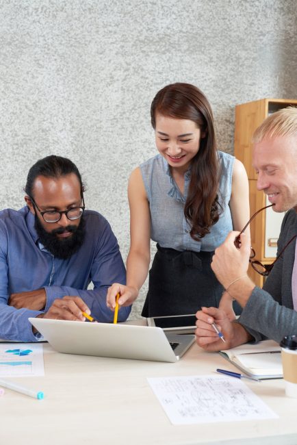 multinational-group-colleagues-looking-laptop-screen-work-meeting-office_1098-20242