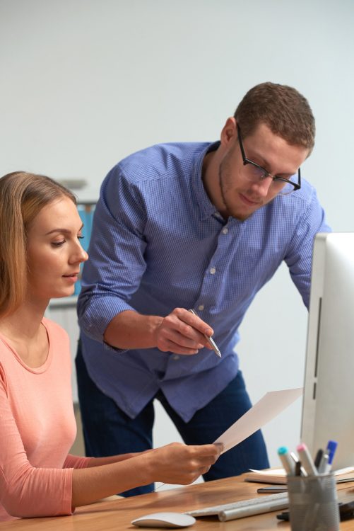 two-business-partners-discussing-business-statistics-using-paperwork_1098-18776