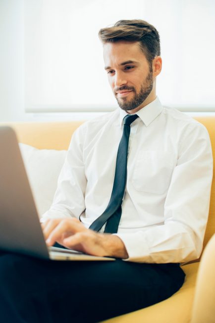 young-executive-working-with-his-laptop_23-2147577258